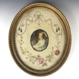 A Georgian embroidery tableau, with central woven silk cartouche depicting a young lady, framed by