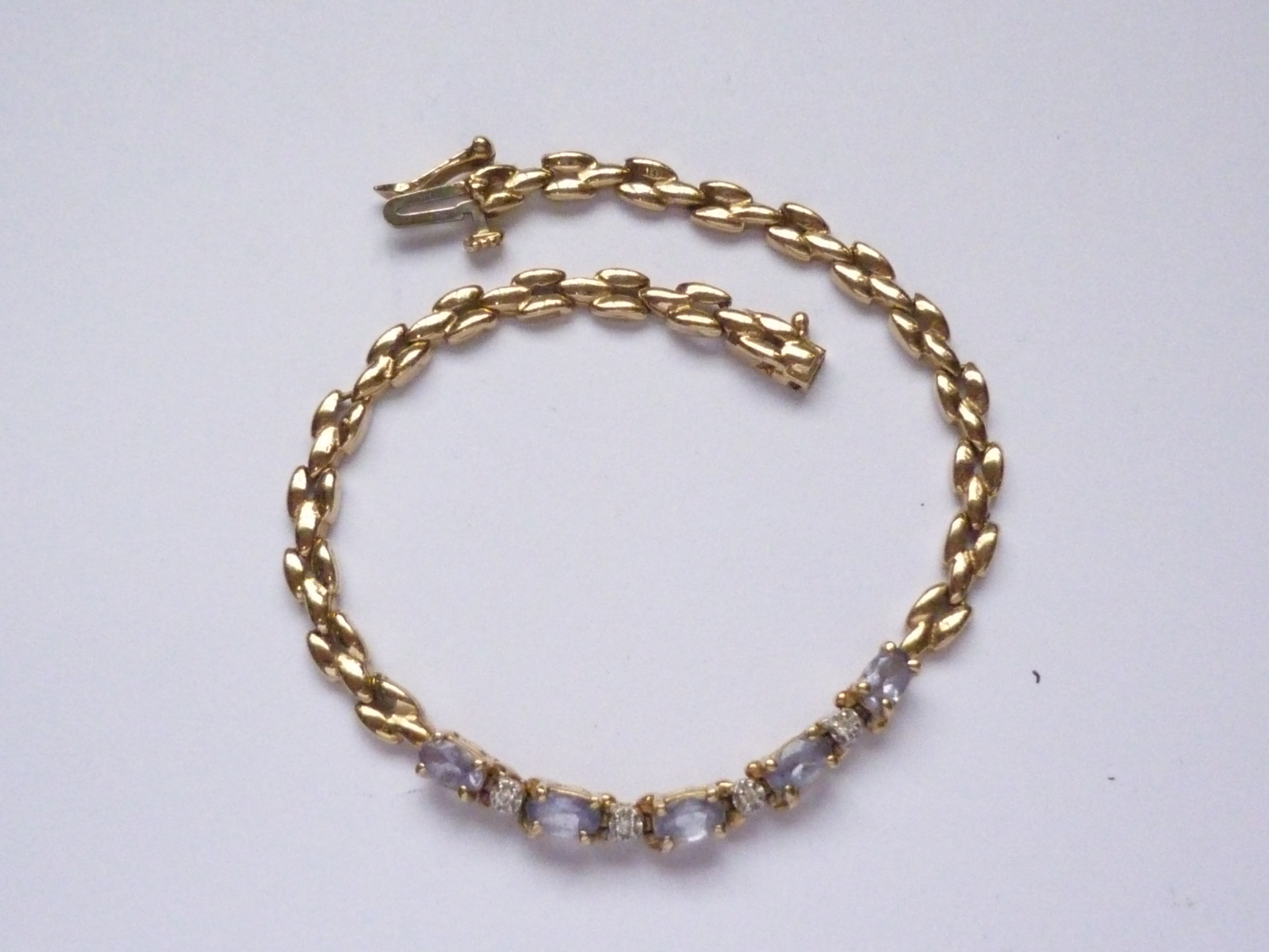 A high carat yellow-metal, diamond and tanzanite bracelet, having five oval-cut and claw set - Image 2 of 2