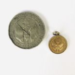 A small Spink type Battle of Jutland Medal in gilt white metal, together with a larger Britannia