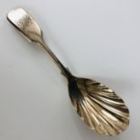 An Edwardian silver fiddle-pattern caddy spoon, with scalloped bowl and engraved monogram to the