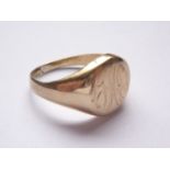 A 9ct gold signet ring, the oval face bearing an engraved monogram, 8.1g