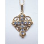 A 9ct gold and tanzanite cruciform openwork pendant, pellet-set with ten round-cut tanzanites,