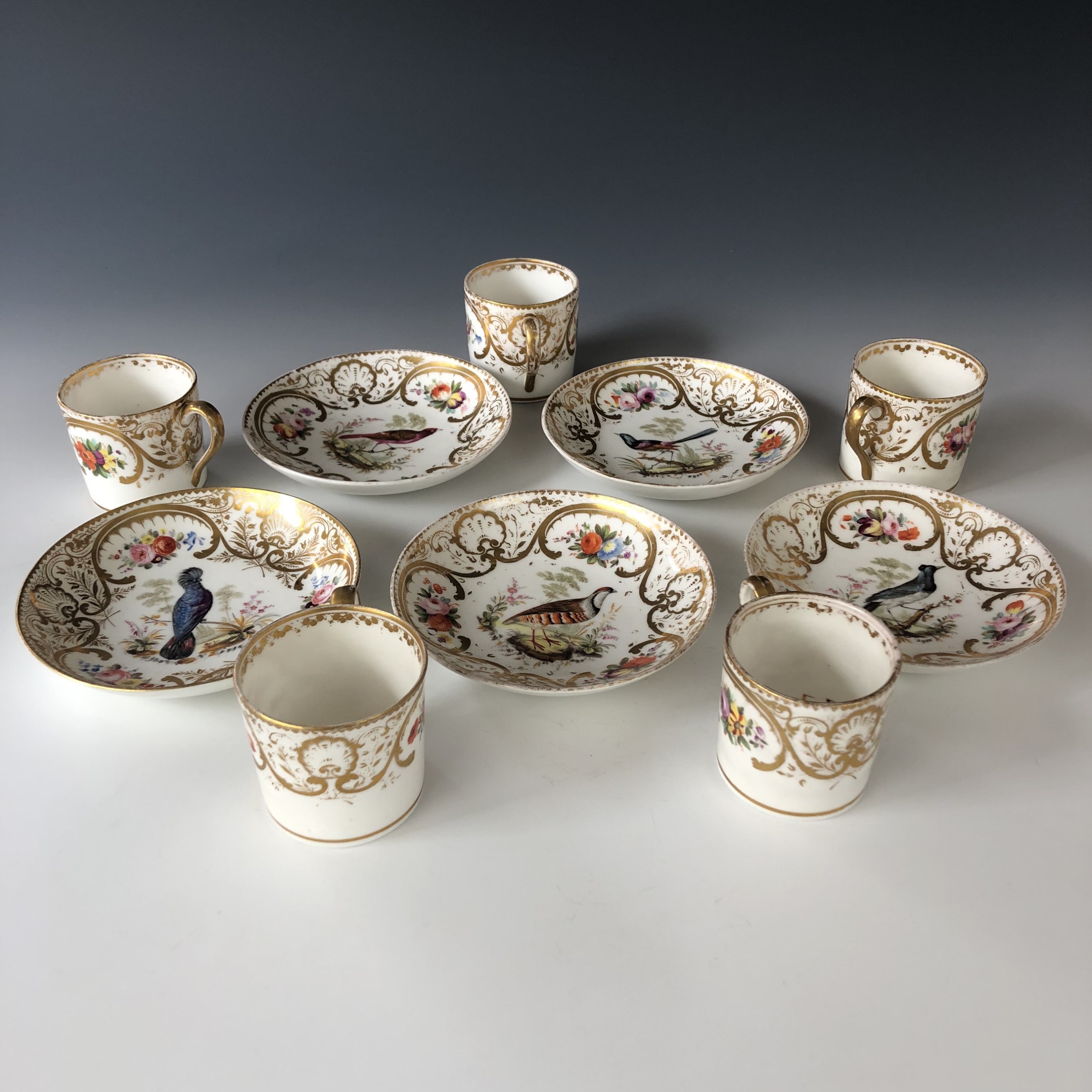 A set of five porcelain coffee cans and saucers, each decorated with a different exotic bird in - Image 2 of 2