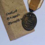 A German Third Reich West Wall Medal in packet