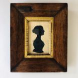 A 19th century cut paper silhouette of a young lady, framed under glass, 9 x 6 cm