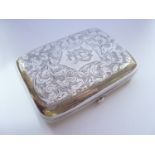 An Edwardian silver cigarette case, of cushion shape, having bright-cut scrolling foliage,
