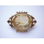 A Victorian yellow-metal (tested as gold) and citrine Gothic Revival brooch, the oval-cut citrine of