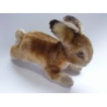 An early 20th Century Steiff miniature bunny, modelled in the act of running, 12 cm