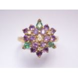 An 18ct gold, diamond, emerald and amethyst cocktail ring, in a flower-head bouquet cluster, with
