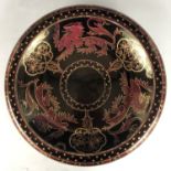 A Grimwades "Byzanta" Ware shallow bowl, decorated with a circular design of three passant dragons