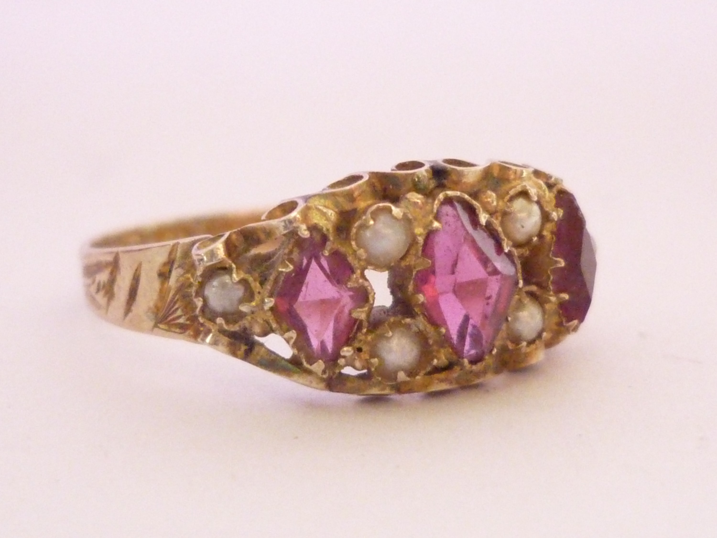 A Victorian almandine garnet and seed pearl dress ring, the open face set with three rhombus-cut - Image 2 of 3