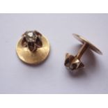 An antique pair of diamond and yellow-metal shirt studs, each having an old-cut diamond solitaire,