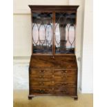 A Sheraton revival astragal-glazed mahogany bureau bookcase, 127 cm x 238 cm