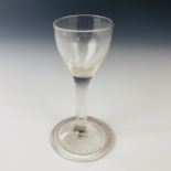A Georgian plain stemmed wine glass, having an ogee bowl and folded foot, 12 cm
