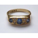 An antique 18ct gold, sapphire and diamond ring, the lenticular face pellet-set with three graded