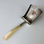 A Georgian silver caddy spoon, in the form of a shovel, with engraved chequered decoration to the