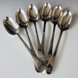 A matched set of six Georgian silver Old English bead pattern table spoons, the terminal engraved