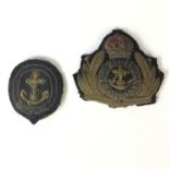 A Royal Navy Transport Service officer's cap badge and one other bullion-embroidered naval badge