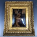 A 19th century crystoleum depicting a young lady seated in a woodland setting, in a moulded gilt