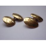 A pair of high-carat yellow metal cuff links, of convex oval form, test as gold, 9.7g