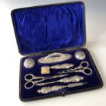 An Edwardian Art Nouveau silver eight-piece manicure set, each element having repousse moulded and