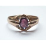An antique 9ct gold and almandine garnet dress ring, the oval-cut and claw-set garnet of