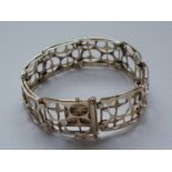 A mid-20th century Modernist design 9ct gold articulated bracelet, having eight layered plaques,