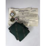 Women's Land Army tie cap and other badges. together with WLA discharge document