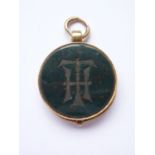 A Victorian locket fob fabricated from a George III gold spade guinea and bloodstone matrix, the