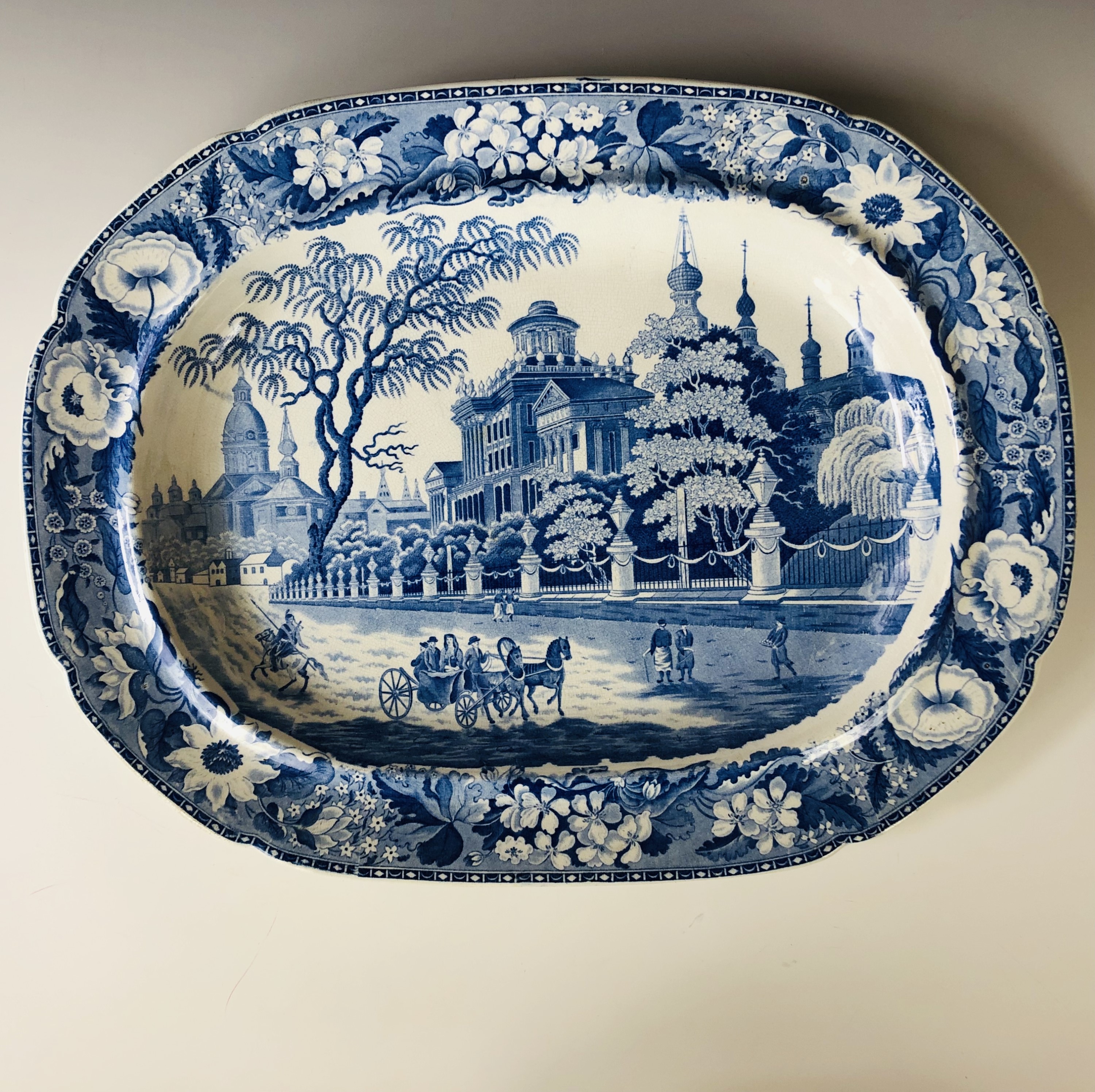 An early 19th century blue and white transfer-printed ashet, depicting a street scene with - Image 2 of 2