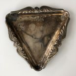 An Elizabeth II silver pin dish, of triangular section with cusped and scrolling rim flange, A Chick