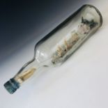 A 1920s 'ship in a bottle' incorporating a handwritten note of provenance "Best wishes / from Wm