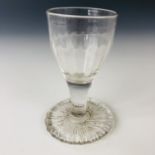 An 18th Century wine glass with over-sewn foot, 10 cm