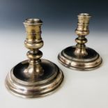 A pair of Elizabeth II silver candlesticks, with knopped stems over a circular foot, John Henry