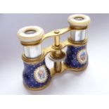 A pair of late 19th / early 20th century mother-of pearl and lacquered brass opera glasses, having