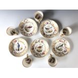 A set of five porcelain coffee cans and saucers, each decorated with a different exotic bird in