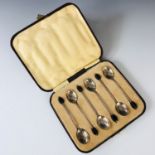 A cased set of six George V silver coffee spoons with black coffee bean terminals, T W & S,