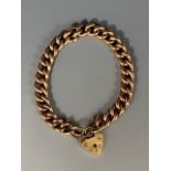 A vintage 9ct gold curb-link charm bracelet with heart-shaped padlock clasp, 17.5g