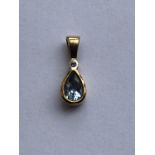 A contemporary yellow-metal, diamond and aquamarine pendant, the brilliant-cut diamond bezel set