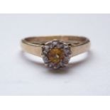 A vintage 9ct gold and citrine dress ring, the round-cut citrine being framed by a faceted white-