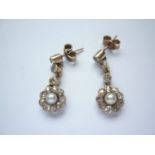 A pair of antique diamond and pearl ear pendants, each comprising three brilliant-cut and millegrain