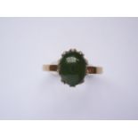 A vintage jade and yellow-metal (tested as gold) dress ring, the jade cabochon of approximately 10 x