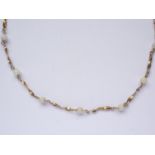 A 1930s 9ct gold and pearl necklace, comprising twisted lemniscate links interspersed by pearls, 9.