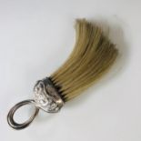 A Victorian silver mounted crumb brush, with gadrooned and looped ring handle, and relief-moulded