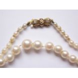 A vintage single-strand necklace of graded pearls, fastening with a 9ct gold bow-shaped box-link