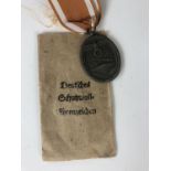 A German Third Reich West Wall Medal and packet