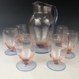 An early 20th century free-blown glass lemonade set, in pink and blue, comprising a jug and six