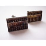 A pair of Chinese white metal novelty cuff links each in the form of an abacus, stamped '