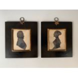 A handed pair of 19th century cut-paper silhouettes, depicting a young lady and gentleman
