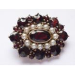 A vintage 9ct gold, garnet and pearl brooch, in a flower-head cluster arrangement, with central
